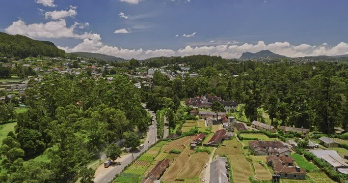Nuwara Eliya Sri Lanka Aerial v1 drone fly along A5 PBC highway towards city center capturing British mansion President's house, golf course and hillside views - Shot with Mavic 3 Cine - April 2023