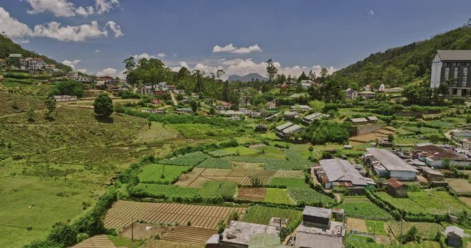 Nuwara Eliya Sri Lanka Aerial v3 cinematic low drone flyover along A5 PBC highway towards golf course capturing hillside residential houses, circuit bungalows - Shot with Mavic 3 Cine - April 2023