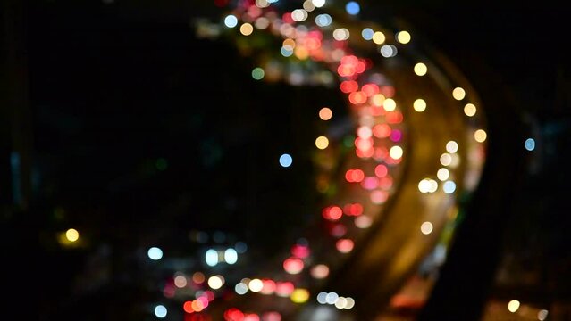 Blurred background night city bokeh car drive on road in nightlife. Light line traffic jam in black night. Blur street flare traffic motion movement. Cityscape Urban dark background twilight time