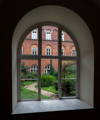 view into the garden from a white window