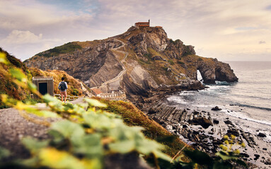 man walking gaztelugatxe landscape