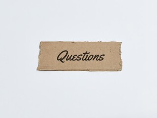 Text question written on brown paper strip against white background.