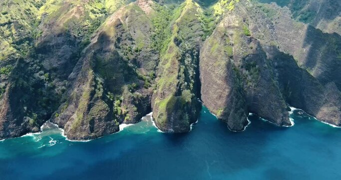 Timelapse Aerial View of Clouds Moving and Sunlight Changing Above Green Tropical Mountains with Clear Blue Ocean Coastline on Fatu Hiva Island in the Marquesas in South Pacific French Polynesia