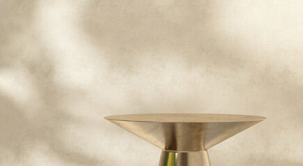 Round gold brass table podium tray in sunlight, leaf shadow on beige brown stucco wall. Luxury,...