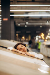 Woman chooses floorboard laminate for home renovation in store