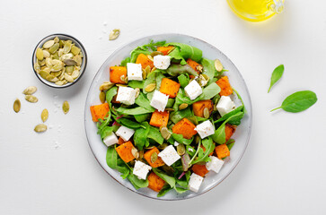 Pumpkin Salad with Arugula, Feta Cheese, and Pumpkin Seeds, Salad Mix with Roasted Pumpkin, Autumn...