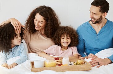 Parents, children and breakfast in bed, morning or excited for love, bonding or care on holiday. Mother, father and kids in bedroom, food and smile together for nutrition, eating or happy family home