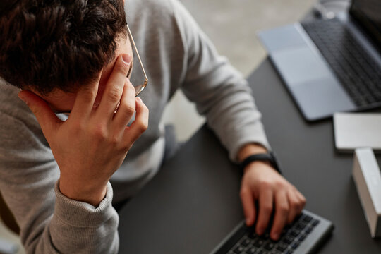 Stressed IT professional sitting at desk