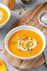 Pumpkin Soup, Tasty Homemade Pumpkin, Sweet Potato, Carrot Soup in a Bowl on Bright Background