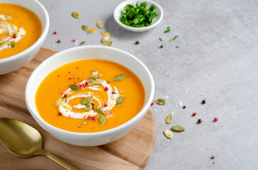 Pumpkin Soup, Tasty Homemade Pumpkin, Sweet Potato, Carrot Soup in a Bowl on Bright Background