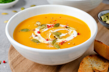 Pumpkin Soup, Tasty Homemade Pumpkin, Sweet Potato, Carrot Soup in a Bowl on Bright Background