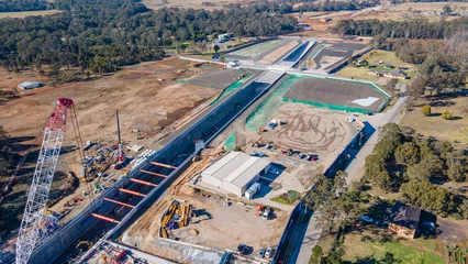 Poster Aerial drone view of the construction site of the new metro station at Orchard Hills in Western Sydney, NSW Australia on a sunny day in August 2023  © Steve