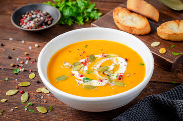 Pumpkin Soup, Tasty Homemade Pumpkin, Sweet Potato, Carrot Soup in a Bowl on Dark Background