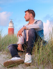 Texel lighthouse during sunset Netherlands Dutch Island Texel Holland, men on vacation at the Dutch...