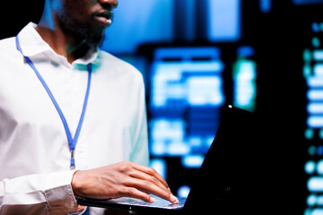 Engineer using laptop to optimize VPN servers with top security standards used to protect sensitive data. Technician working in enterprise data business providing online connections for users