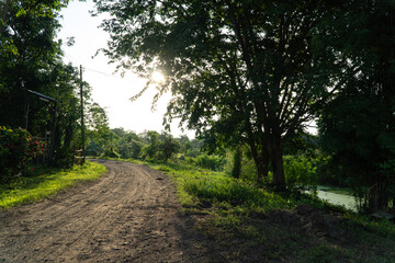 Sunset at small dirt road in rural northeastern region of Thailand