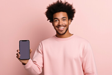 Happy African American teen student holding mobile cell phone pointing finger at smartphone mock up big screen template presenting application, using cellphone showing ad isolated on beige background. - obrazy, fototapety, plakaty