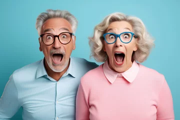 Tuinposter cheerful middle aged woman and her husband pensioner reacts on shocking news © wolfhound911