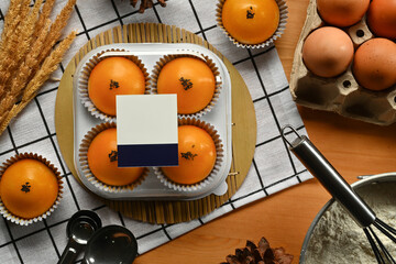 Chinese pastry with stuffed salted yolk on wooden kitchen table. Traditional dessert for Chinese Mid-Autumn festival.