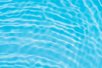 Blue water with ripples on the surface. Defocus blurred transparent blue colored clear calm water surface texture with splashes and bubbles. Water waves with shining pattern texture background.