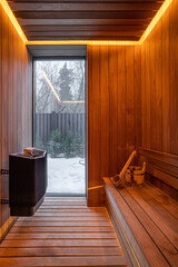 Finnish sauna interior with broom and bucket