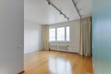 view of an empty room without furniture for rent or sale, white walls, large window with curtains