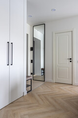modern hallway interior design in Scandinavian style, wardrobe, mirror, entrance crap, white color and wooden parquet, laminate