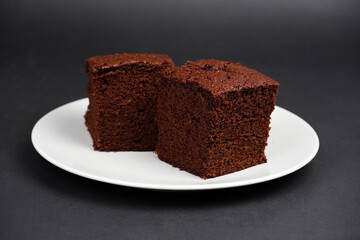 Chocolate Brownie in plate isolated on black background              