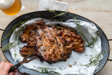 Grilled pork steak on a meat fork