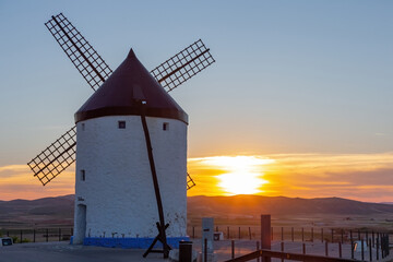 Mills in the town of Consuegra. Landscape of several white windmills and brown windmills on the hill. ancient architecture. Farm houses.