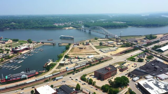 Aerial view following a riverboat leaving the Dubuque town at the Mississippi river, in sunny Iowa, USA