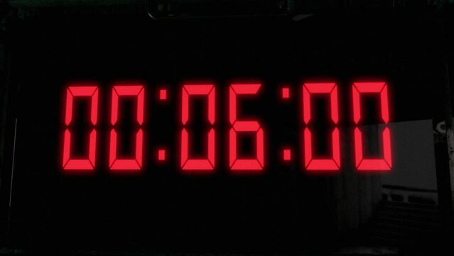High quality CGI render of a digital countdown timer on a wall-mounted screen, with glowing red numbers, counting down from 10 to zero, with with camera slowly pushing in dramatically