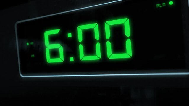 High quality CGI render of a digital alarm clock, with glowing green numbers, ticking over from 5.59 to 6.00 a.m. with dramatic right to left camera move - wake up time