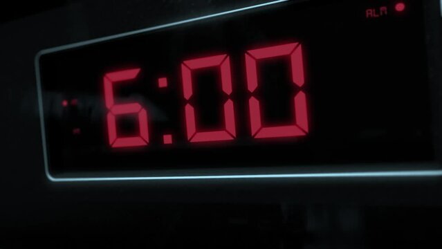 High quality CGI render of a digital alarm clock, with glowing red numbers, ticking over from 5.59 to 6.00 a.m. with dramatic right to left camera move - wake up time