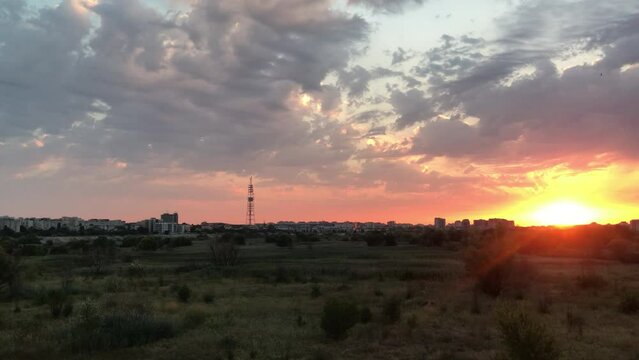 City Skyline sunset panoramic view. Dramatic Clouds, Golden Hour horizon,  4K fluid motion, Bucharest, Delta Vacaresti, travel tourism concept  