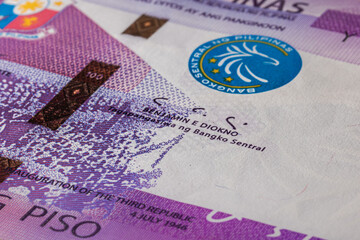 Extreme macro photography of a 100 Peso banknote. Ultra close up of a one hundred filipino peso note. Legal Tender for private and public of the island state of the Philippines. Microscopic capture - obrazy, fototapety, plakaty