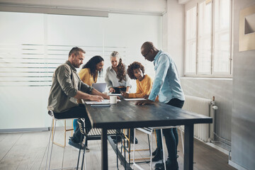 Diverse businesspeople working together around a table in an office