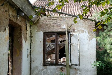 Close up of wall of building destroyed by fire. Broken window.