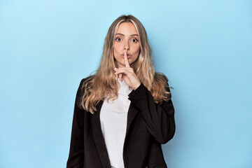 Caucasian woman in business jacket keeping a secret or asking for silence.