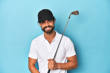 Long-haired golfer with club and hat laughing and having fun.