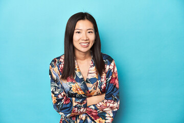 Fototapeta premium Elegant young Asian woman in kimono, studio shot laughing and having fun.