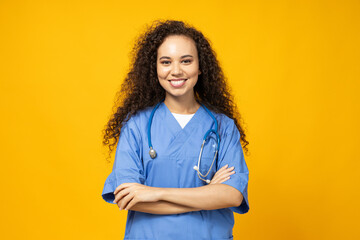 An attractive young girl in a blue nurse's uniform on a yellow background