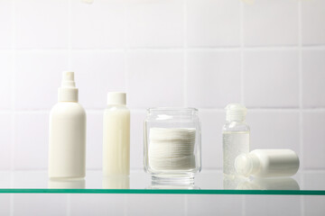 Cotton pads in a jar on the bathroom shelf.