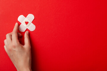 Plaster with a black heart on a red background. Blood donation, place for text