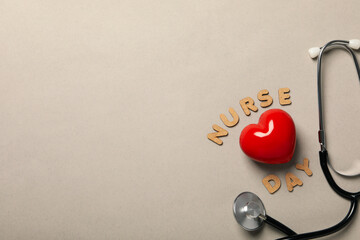 Red heart with a stethoscope on a light background. Blood donation, place for text