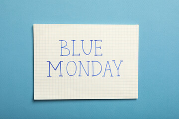 Paper with text Blue Monday on blue background, top view