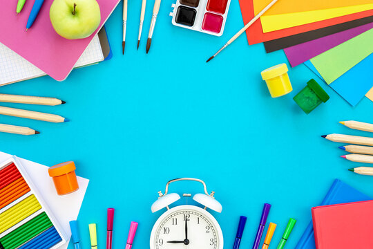 Various school education and office supplies, accessories on a blue background.
