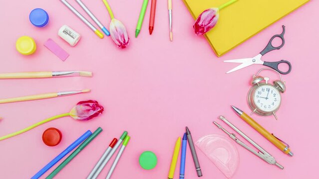 Stop motion animation Multicolor school stationery supplies tools moving in circle frame.Back to school,education,childhood,primary school on pink background.copy space Top view 4k