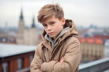 Sadness Boy In A Beige Coat On City Background. Сoncept Feeling Isolation In An Urban Environment, Sadness In Young Boys, The Impact Of Clothing And Colours On Moods, Mental Health In City Life