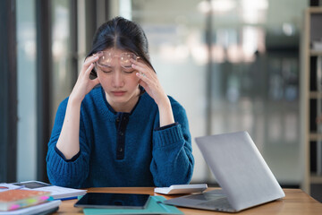 Young Asian businesswomen with office syndrome have a problem with feeling headaches and stress...